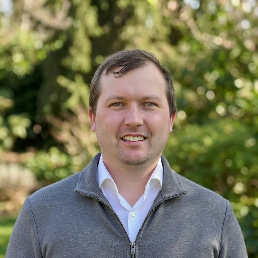 Jaime Mitchell, Founder and Director of Signal Boost Digital, in a grey quarter-zip pullover